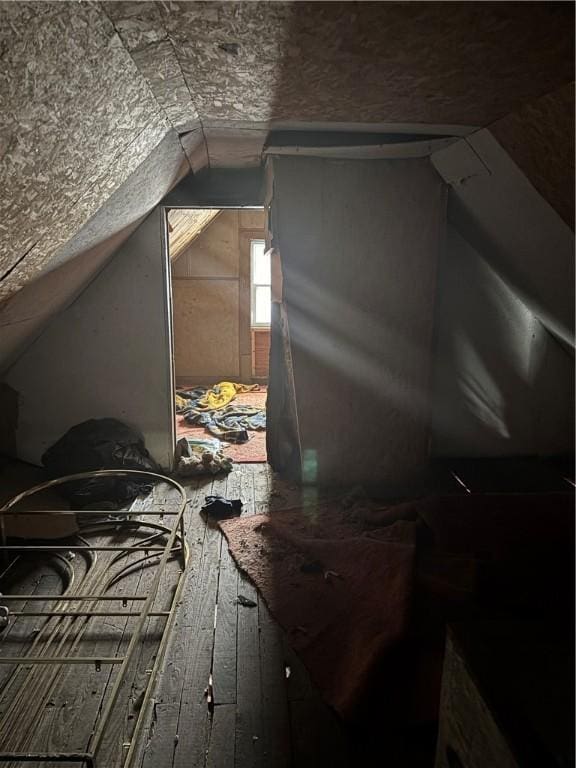 bonus room with wood-type flooring and lofted ceiling