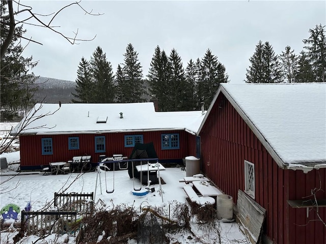 view of snow covered rear of property