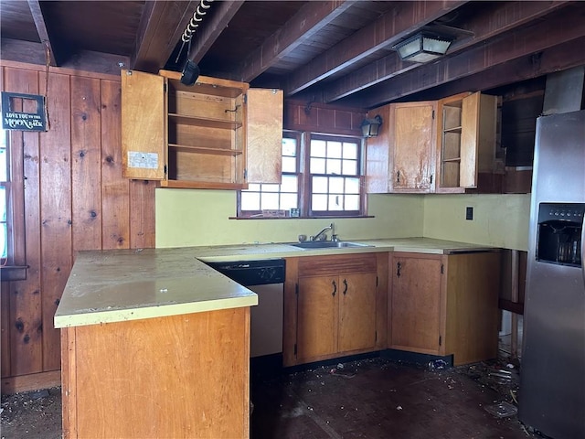 kitchen featuring sink, stainless steel appliances, and wooden walls