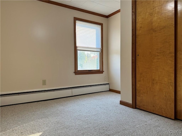 unfurnished bedroom with baseboard heating, light carpet, and crown molding