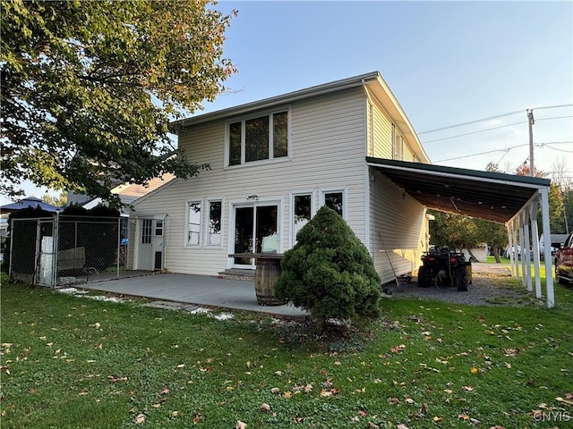 rear view of property with a carport and a lawn