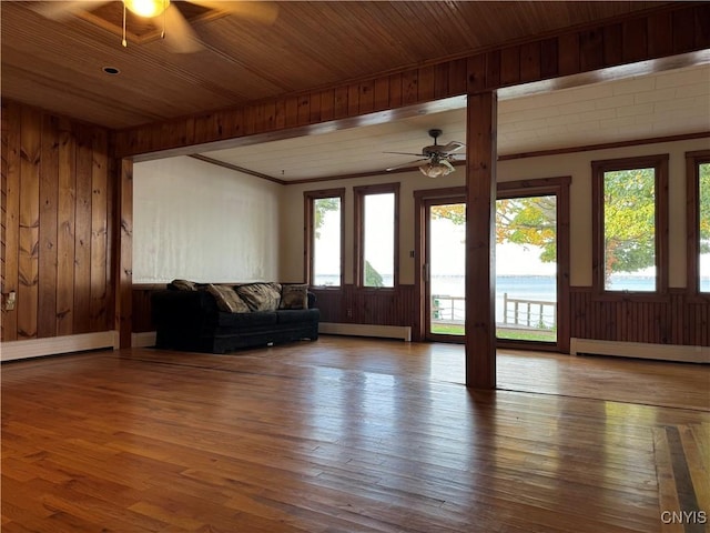 living room featuring ceiling fan, wood-type flooring, and a baseboard heating unit