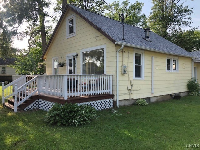 back of house featuring a yard and a deck