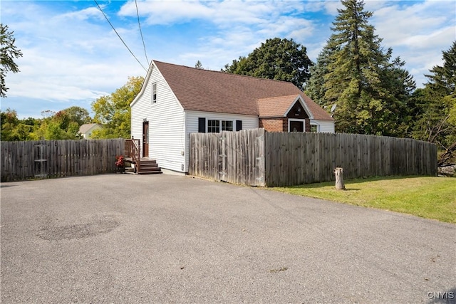 view of side of property with a yard