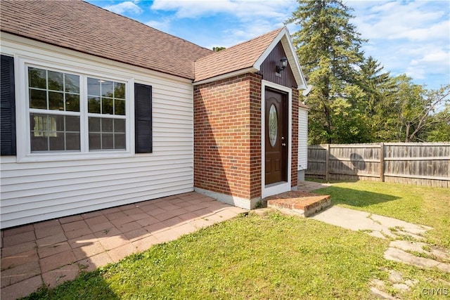 entrance to property featuring a yard