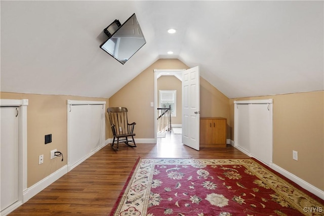 bonus room featuring hardwood / wood-style flooring and vaulted ceiling