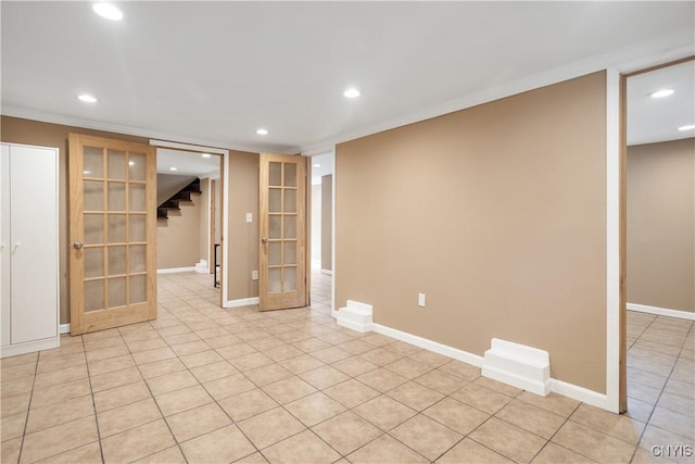 basement with french doors and light tile patterned floors