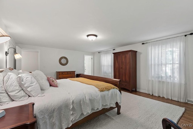 bedroom with dark hardwood / wood-style floors