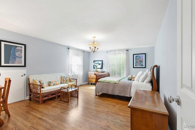 bedroom with a chandelier and hardwood / wood-style flooring