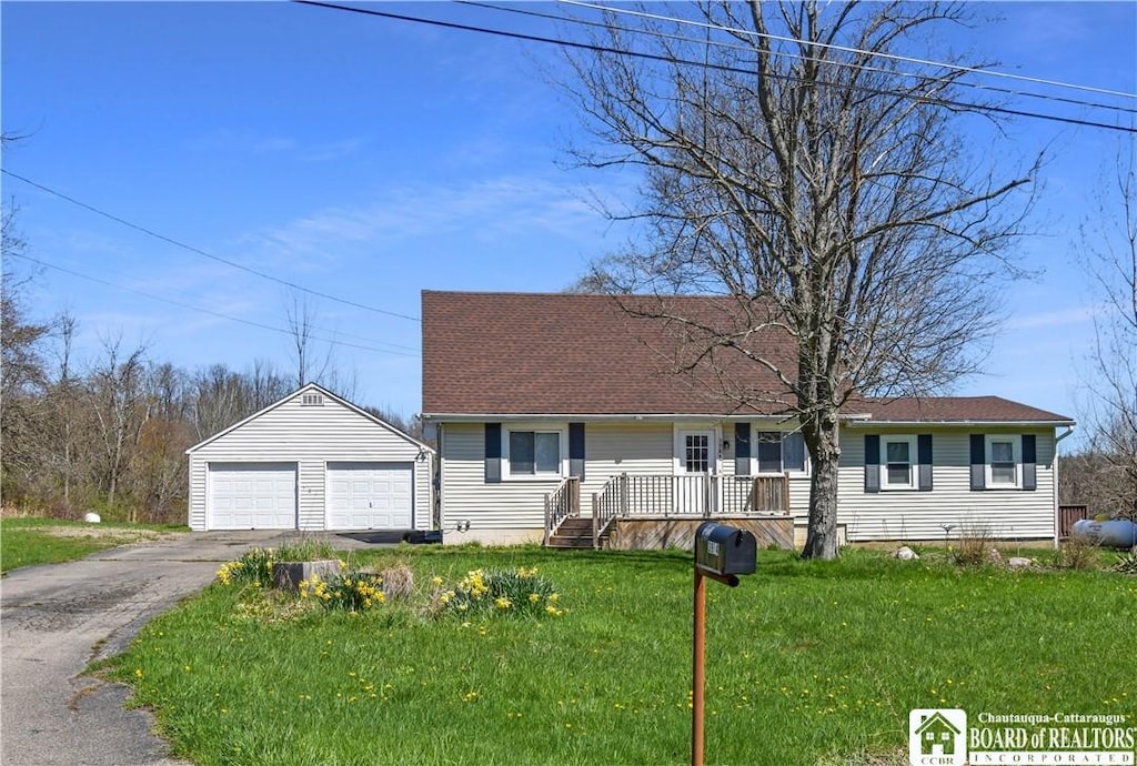 view of front of home with covered porch, a garage, an outdoor structure, and a front yard