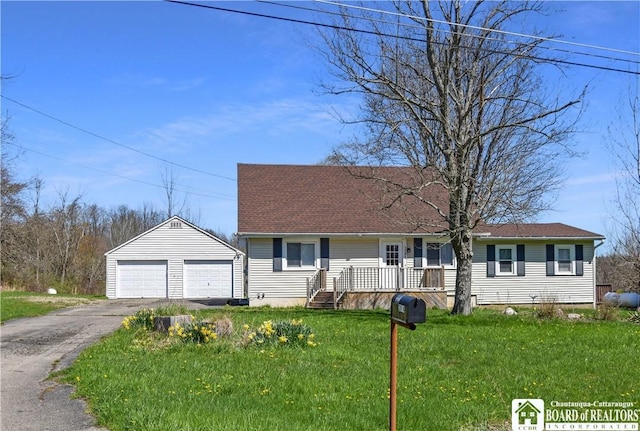 view of front of home with covered porch, a garage, an outdoor structure, and a front yard