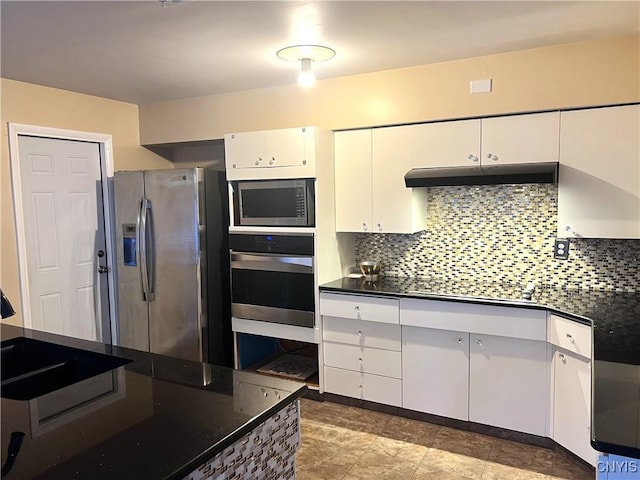 kitchen with white cabinets, appliances with stainless steel finishes, and backsplash