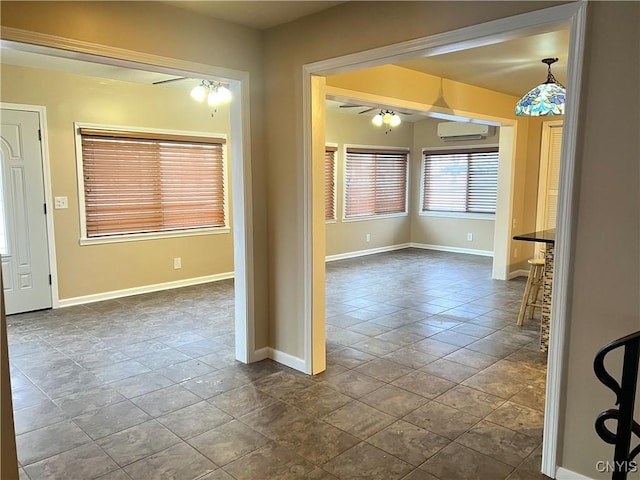 unfurnished dining area with an AC wall unit and ceiling fan