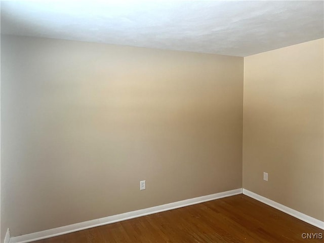 empty room with dark wood-type flooring