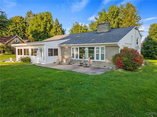 back of property with a patio and a lawn