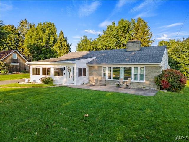 rear view of house featuring a lawn and a patio area