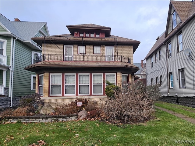 exterior space with a balcony and a front lawn