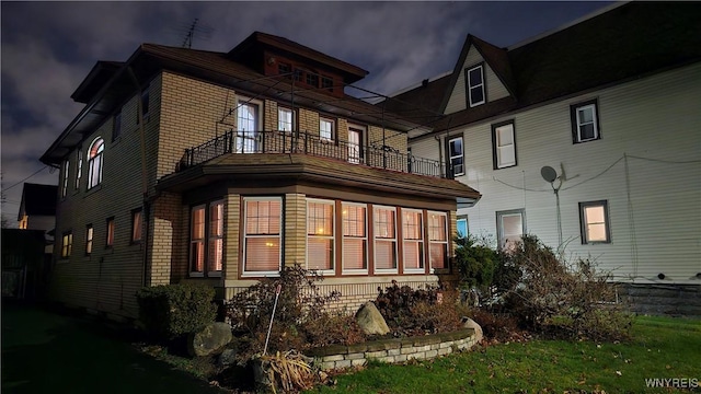 view of side of property featuring a balcony