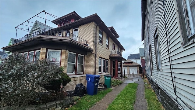 view of side of home with a balcony