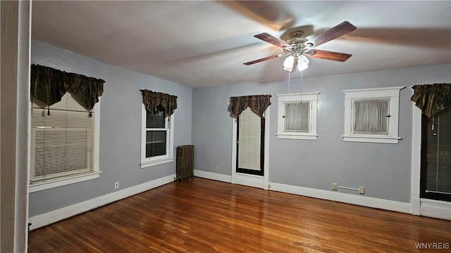 unfurnished room featuring ceiling fan and dark hardwood / wood-style flooring