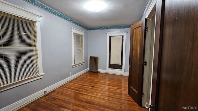 hallway featuring wood-type flooring and radiator