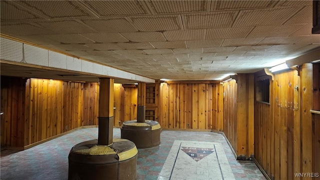 basement featuring wooden walls