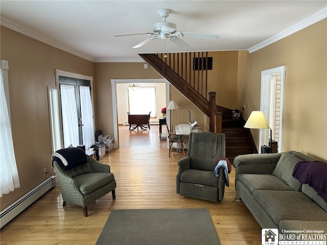 living room with light hardwood / wood-style flooring, baseboard heating, crown molding, and ceiling fan