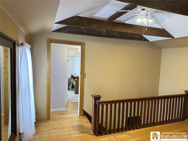 corridor featuring vaulted ceiling with beams and light hardwood / wood-style flooring