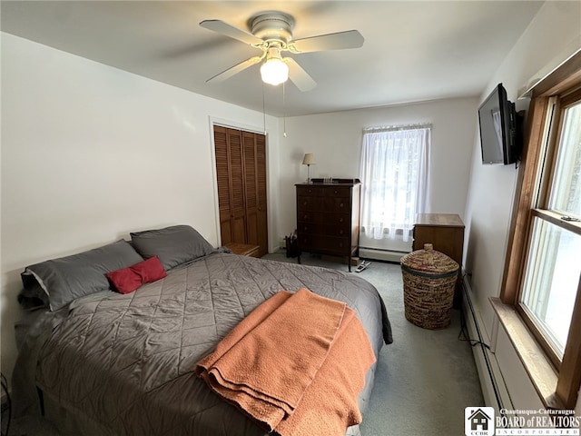 bedroom featuring ceiling fan, light colored carpet, baseboard heating, and a closet