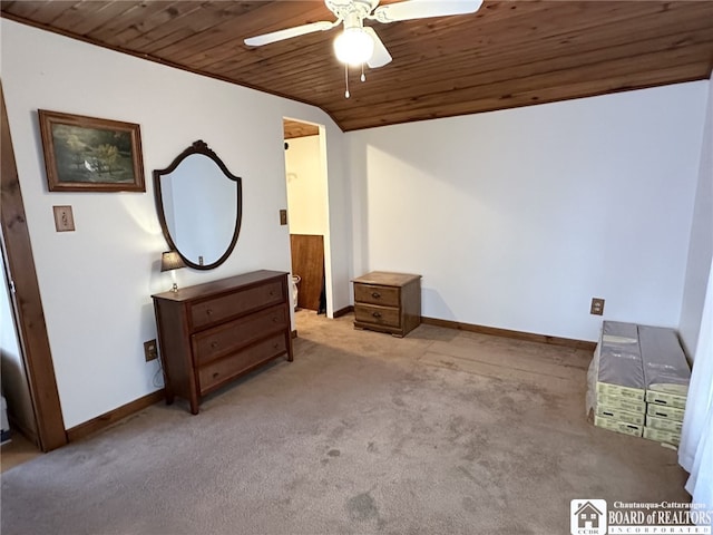 unfurnished bedroom with light carpet, vaulted ceiling, ceiling fan, and wood ceiling