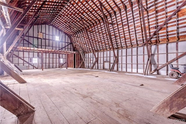 miscellaneous room with hardwood / wood-style floors and vaulted ceiling