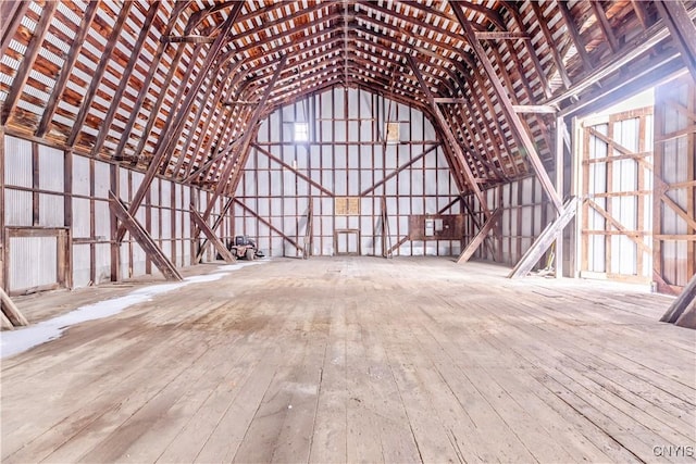 miscellaneous room with wood-type flooring and lofted ceiling