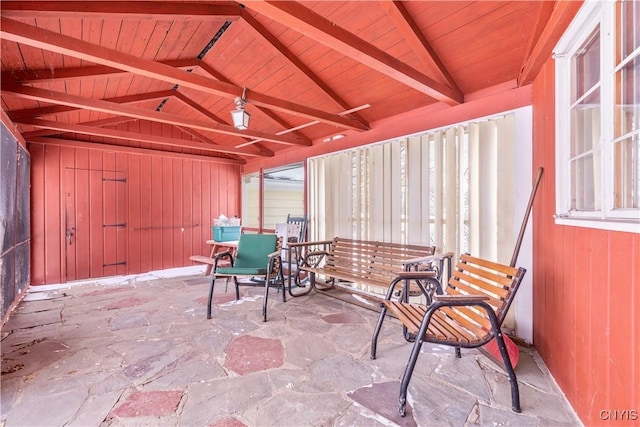 sunroom / solarium with vaulted ceiling with beams and wooden ceiling