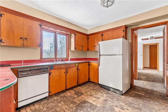 kitchen with white appliances, a baseboard heating unit, and sink