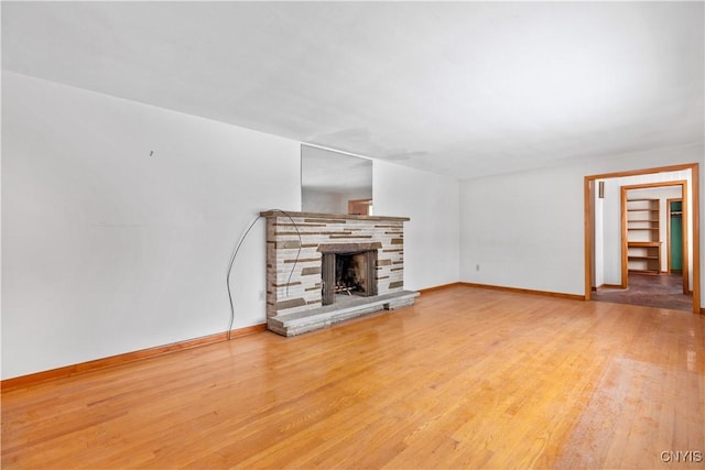 unfurnished living room with a fireplace and wood-type flooring