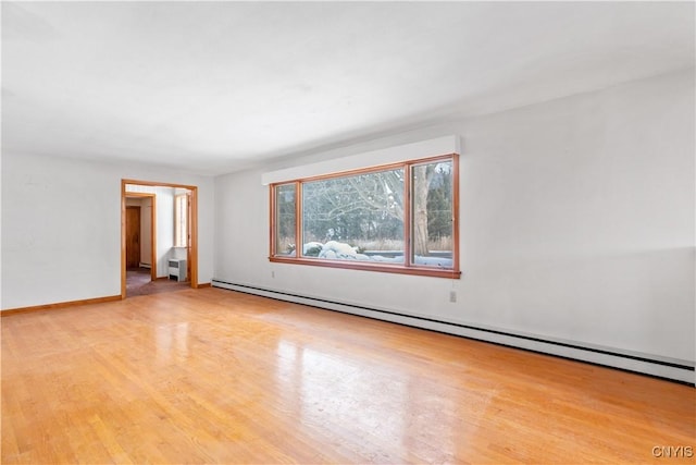 unfurnished room featuring light hardwood / wood-style floors and baseboard heating