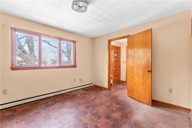 empty room featuring a baseboard heating unit