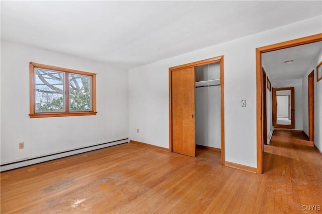 unfurnished bedroom featuring light hardwood / wood-style floors and a baseboard radiator