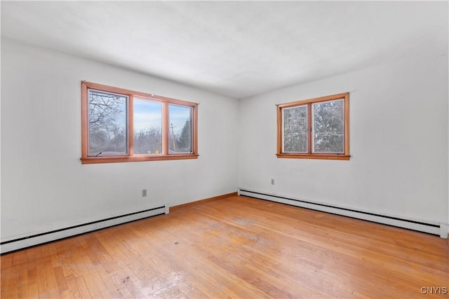 spare room with light hardwood / wood-style floors and a baseboard heating unit