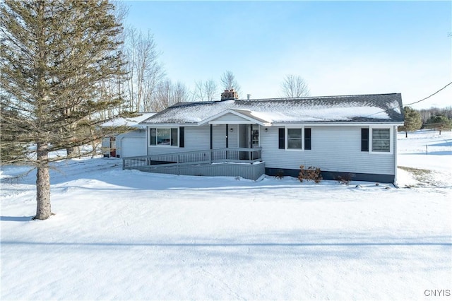 ranch-style house with a garage and covered porch