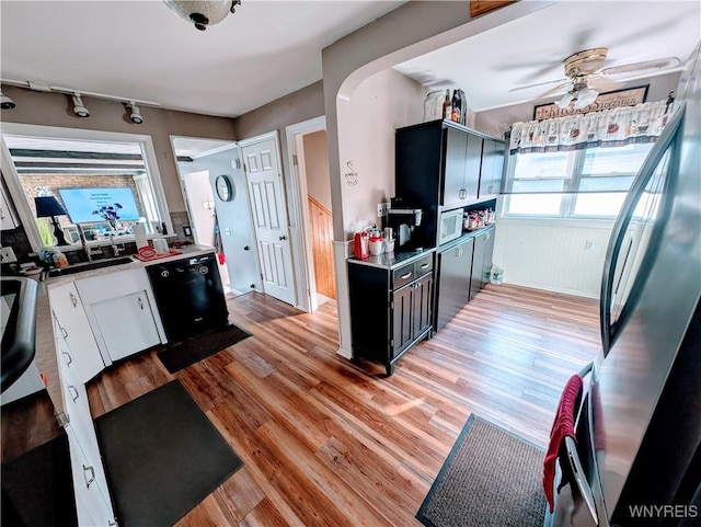 kitchen featuring dishwasher, stainless steel refrigerator, ceiling fan, and light hardwood / wood-style floors