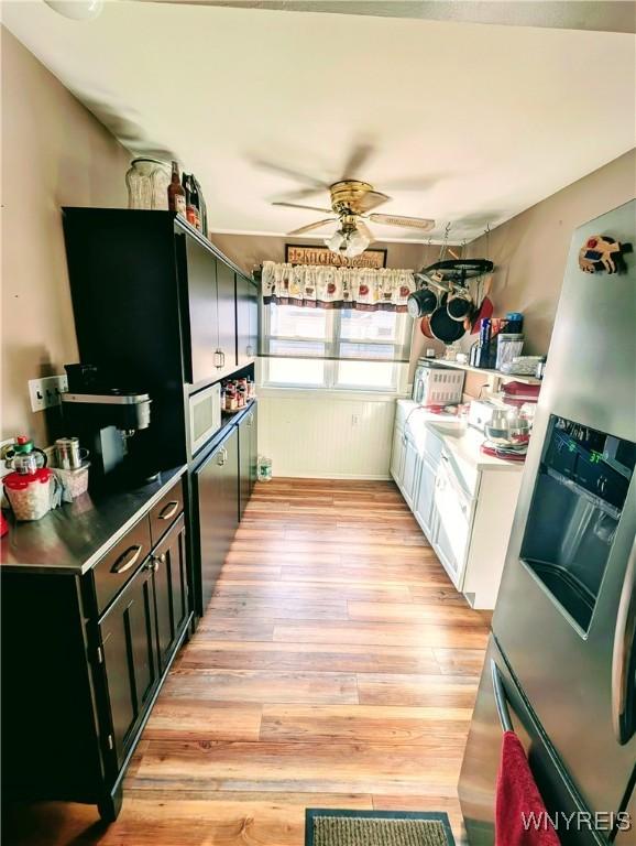 kitchen with ceiling fan, light hardwood / wood-style floors, and stainless steel fridge with ice dispenser