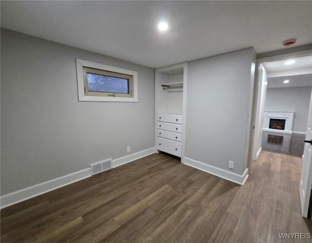 unfurnished bedroom with dark hardwood / wood-style floors