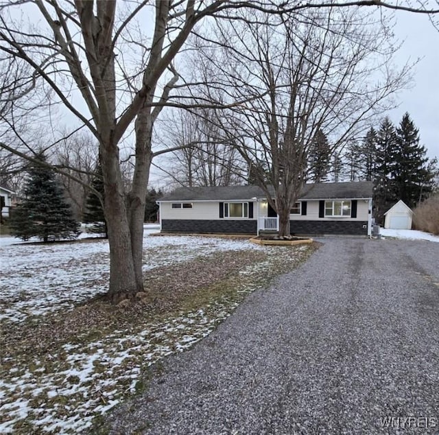 view of front of property featuring an outdoor structure and a garage