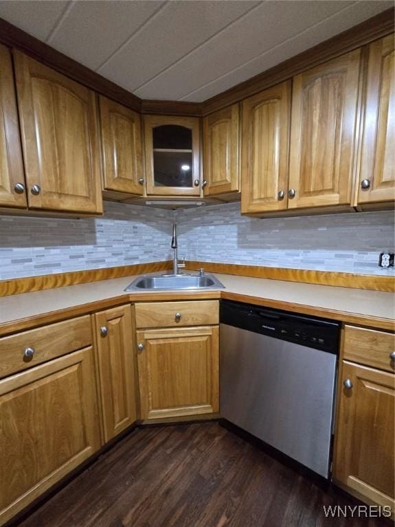 kitchen with stainless steel dishwasher, dark hardwood / wood-style floors, and sink