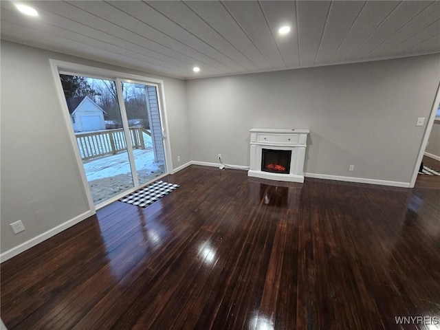 unfurnished living room with wooden ceiling and dark wood-type flooring