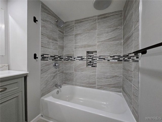 bathroom with vanity and tiled shower / bath