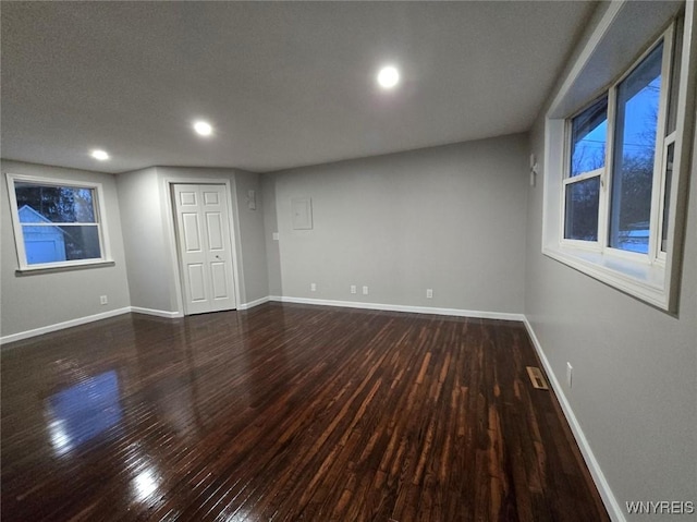 empty room featuring dark hardwood / wood-style flooring