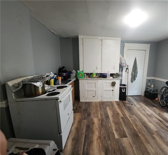 kitchen with white cabinets, dark hardwood / wood-style flooring, and white electric stove