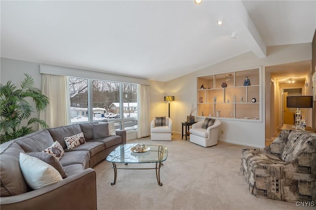 carpeted living room featuring lofted ceiling with beams